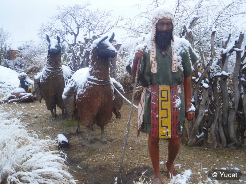 La escultura del pastor comechingón con sus llamas, cubierta de nieve.